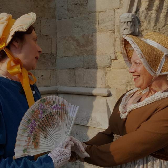 Two women dressed in Regency attire to celebrate Jane Austen 250th birthday