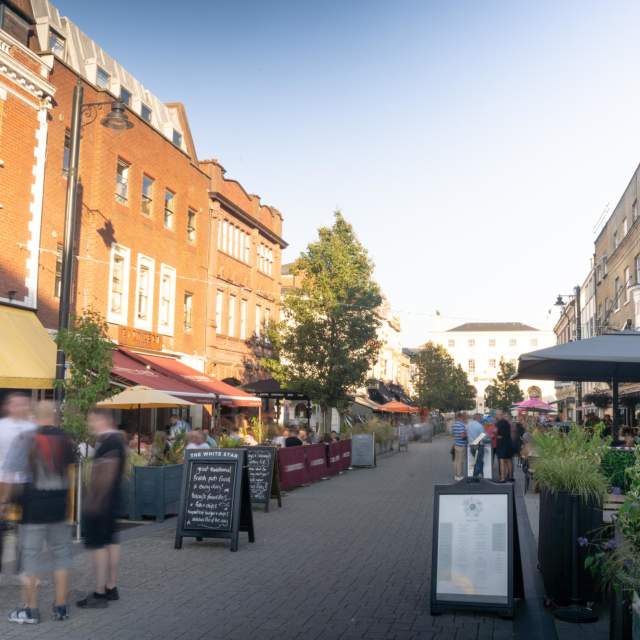 Street with restaurants either side and people walking
