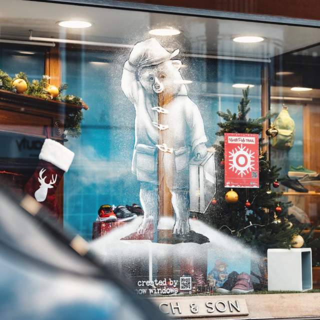 Snowy artwork of Paddington bear in the window of WJ French & Son shoe shop