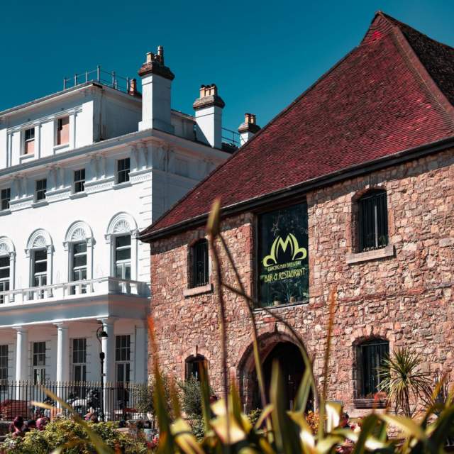 Exterior shot of Dancing Man Brewery building and white building next to it