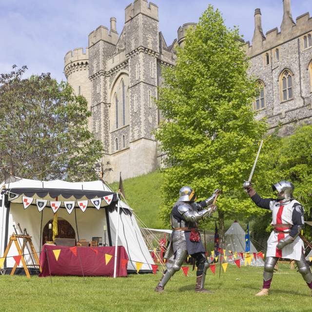 Two knights in medieval costume and armour in the grounds of Arundel Castle, Sussex