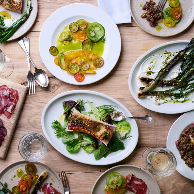 A selection of plates of vegetables and meat at Wilding Kitchen, Knepp