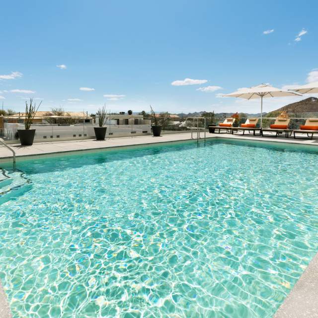 Photo of Tucson's Double Tree Hotel pool with sparkling blue water and lounge chairs
