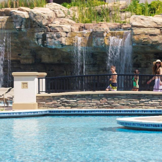 Family walking along grotto pool bridge at Hyatt Regency Orlando