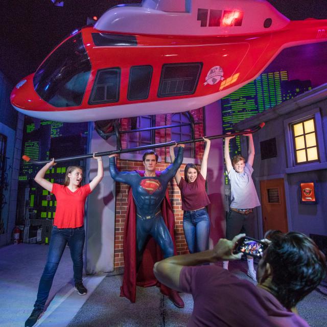 A family poses with Superman at Madame Tussauds in Orlando, Florida.