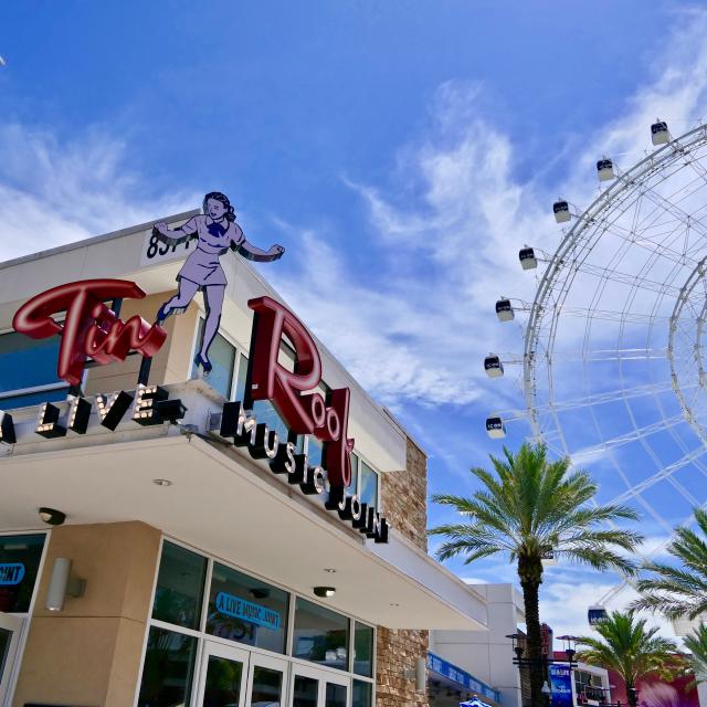 Exterior of Tin Roof, an ICON Park restaurant with The Wheel in the background