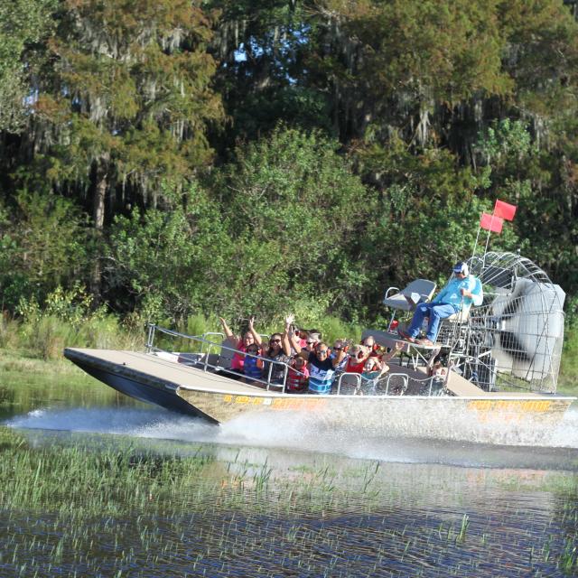 An airboat makes its way across the water at Boggy Creek Airboat Adventures.