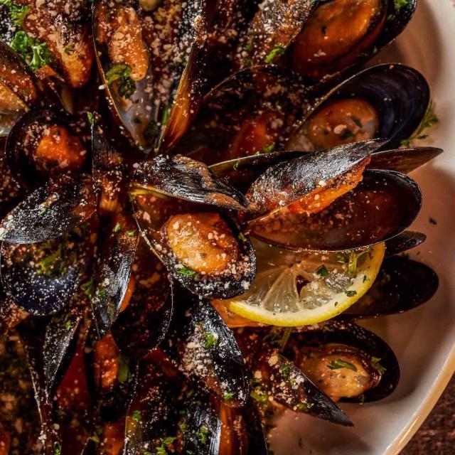 Mussels arranged on a platter with lemon at The Whiskey on Restaurant Row.