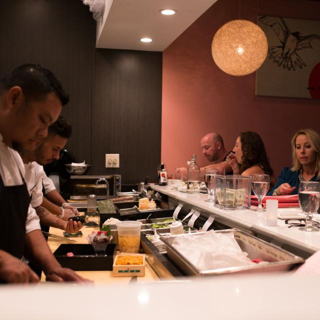 Guests sitting at the sushi bar at Kabooki Sushi, near Downtown Orlando.