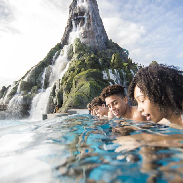 A group of teens gazing into Reef Leisure Pool at Universal's Volcano Bay