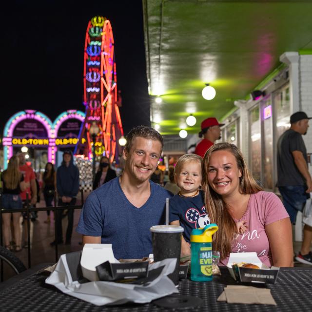 Family dining outdoors during evening at Old Town