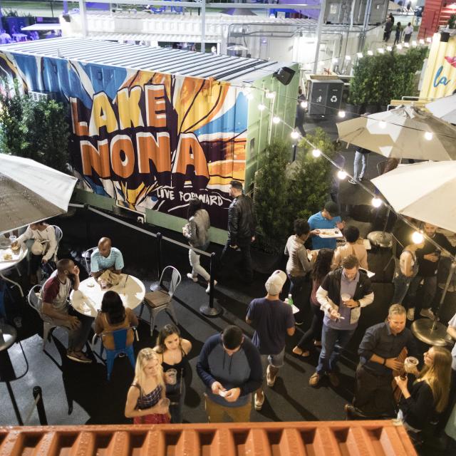 A group of people gathered inside Boxi Park in Lake Nona at night