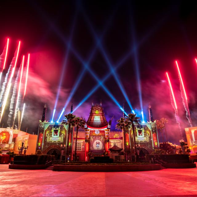 Exterior of the Chinese Theater at Disney’s Hollywood Studios® at night with fireworks