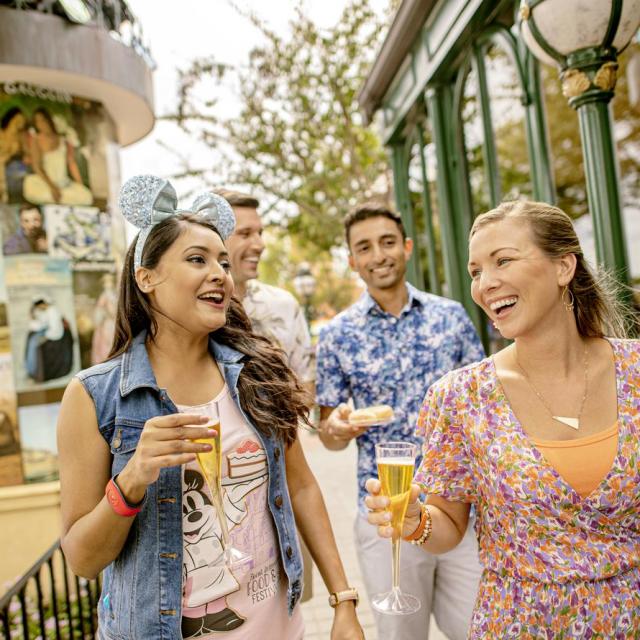Two couples enjoying drinks at the Epcot Food & Wine Festival