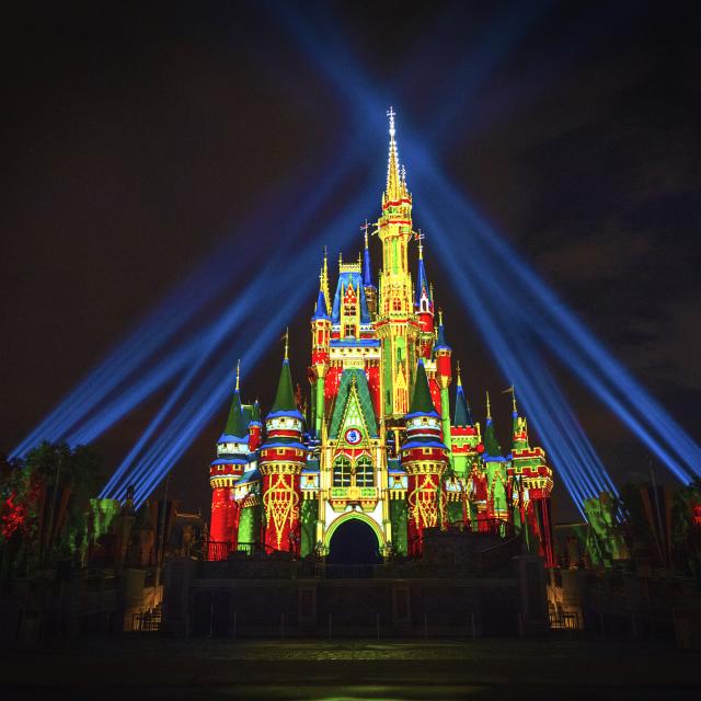 Holiday lights and projections on Cinderella's Castle at Magic Kingdom Park at night
