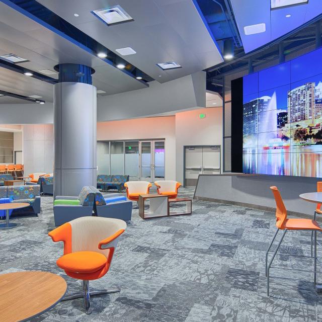 Seating and LED screens inside the Destination Lounge located at the Orange County Convention Center in Orlando