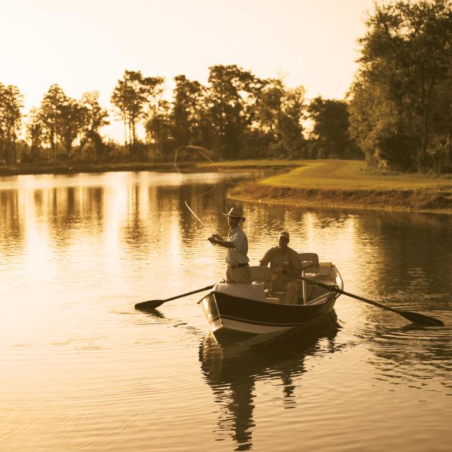 The Ritz-Carlton Orlando, Grande Lakes two men fishing on a boat