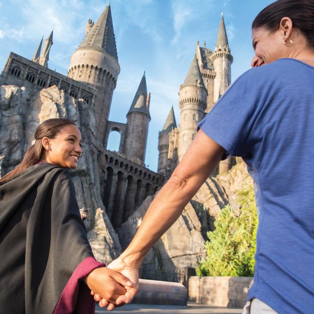 Mother and daughter at the Wizarding World of Harry Potter Hogsmeade at Universal's Islands of Adventure with Hogswarts Castle in the background