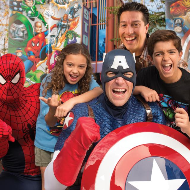 Spider-Man and Captain America posing with a family at Universal's Islands of Adventure