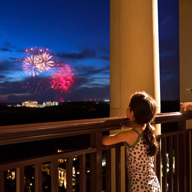 Four Seasons Resort Orlando at Walt Disney World® Resort children watching fireworks from balcony