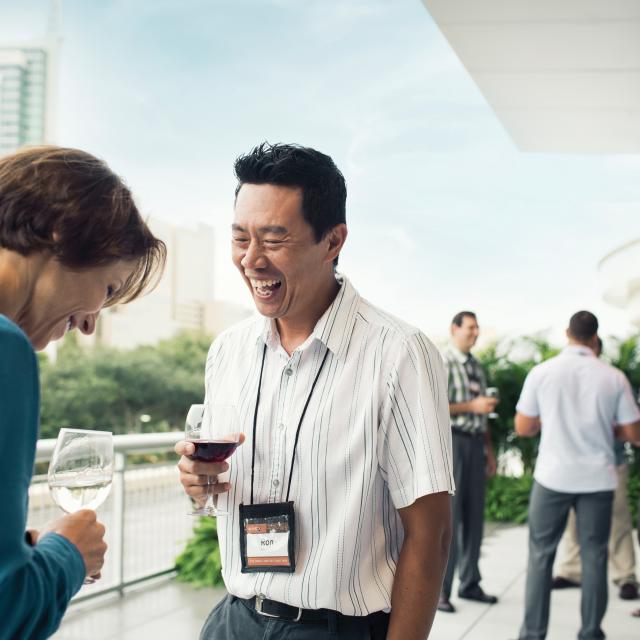Attendees talking and drinking outside of the Orlando/Orange County Convention Center