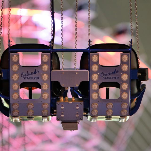 Seats from the Orlando Starflyer attraction, with The Wheel at ICON Park in the background.