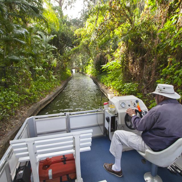 the captain steers the boat through a canal on the Winter Park Scenic Boat Tour