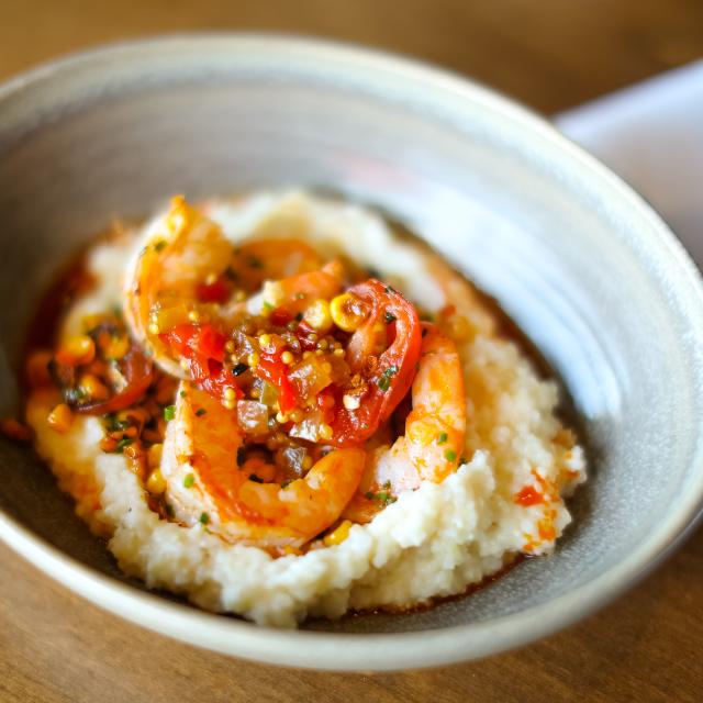 A bowl of shrimp and grits from The Ravenous Pig in Orlando, Florida.