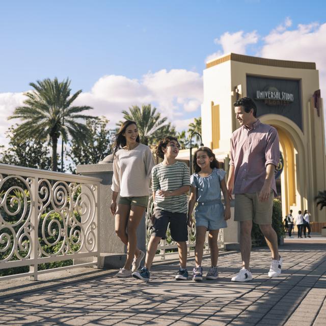 Family of four walking across bridge at Universal Studios