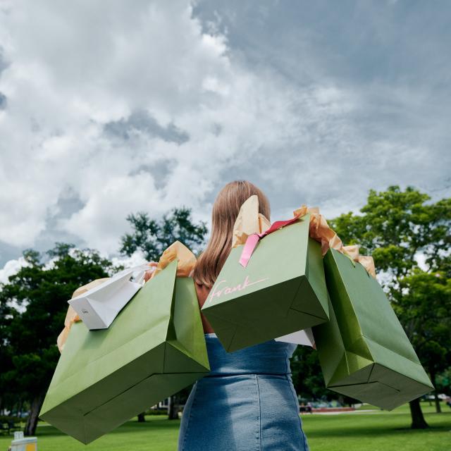 A woman holding shopping bags from Frank store in Winter Park