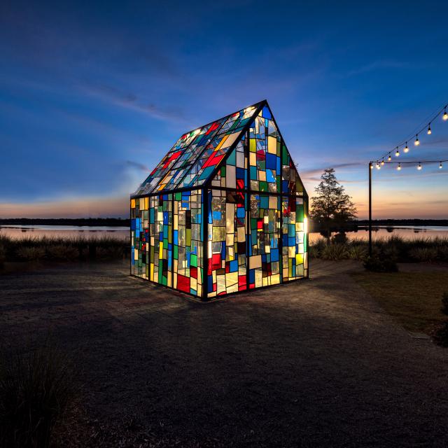 An art installation in Lake Nona at night called "Glass House" by Tom Fruin