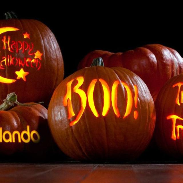 Pumpkins with Visit Orlando logo, Happy Halloween, Boo and Trick or Treat carved on them