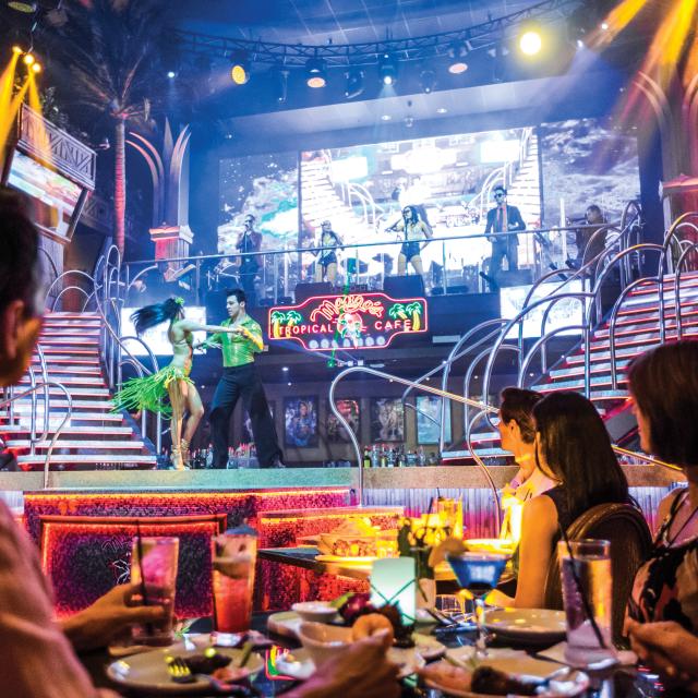 Group dining and watching a performance at Mango's restaurant