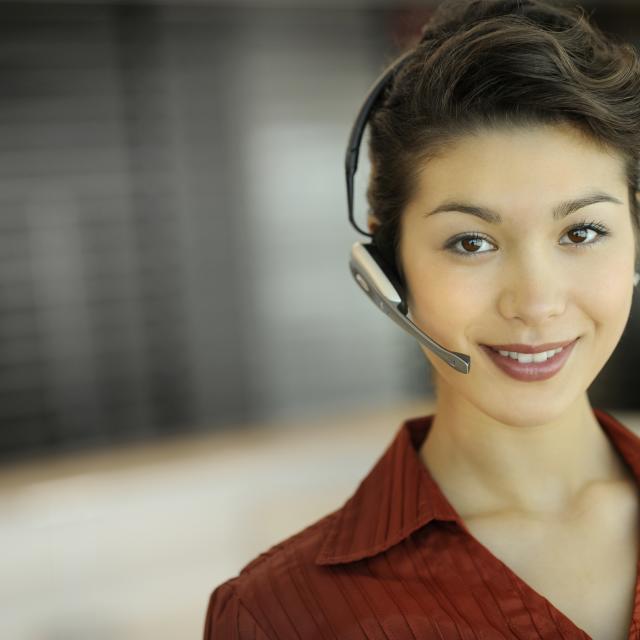 A young businesswoman wearing a headset