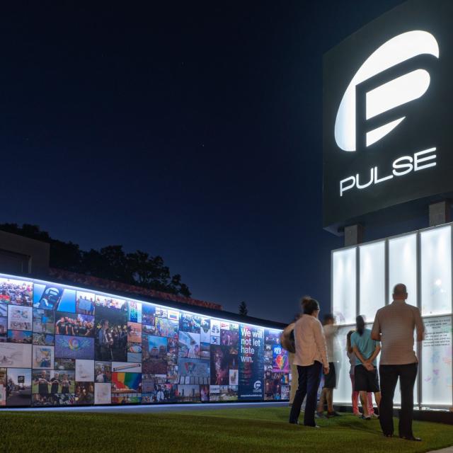Visitors observing the onePULSE Foundation memorial at night