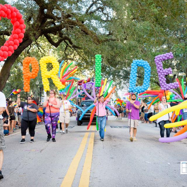 Come Out With Pride parade with pride balloons