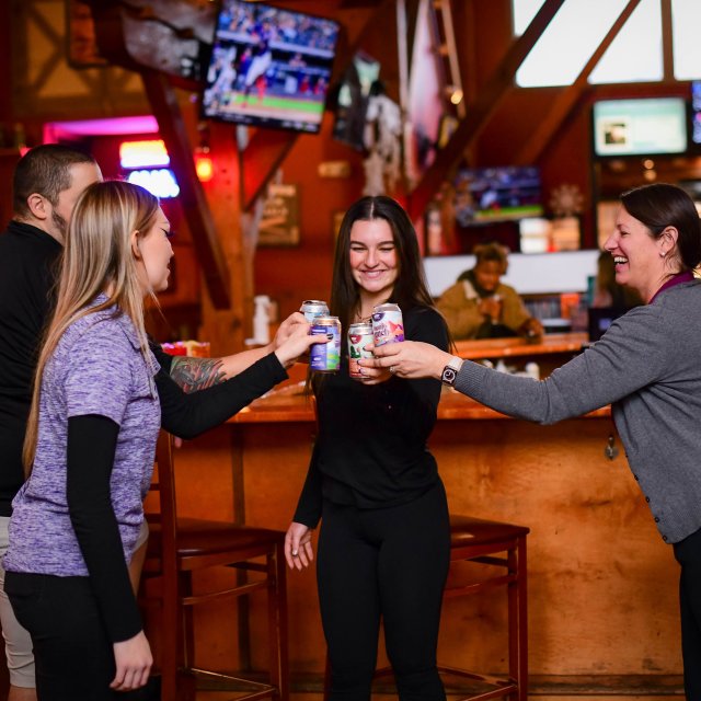 Group of friends making a toast at a Pocono distillery