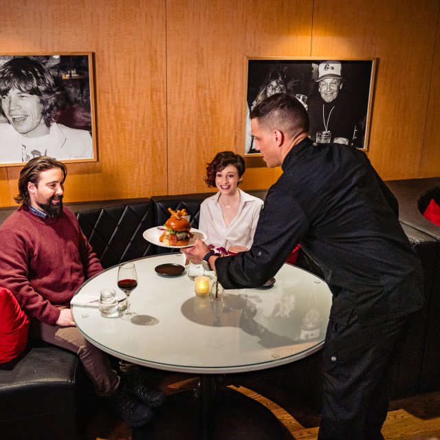A couple being served a meal at the Hotel Fauchere,