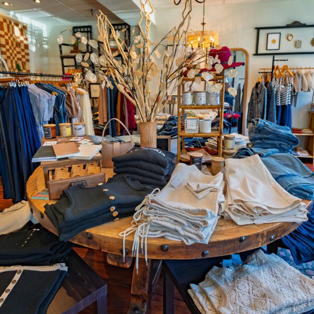 Clothing, accessories, and gift items arranged inside a boutique shop.