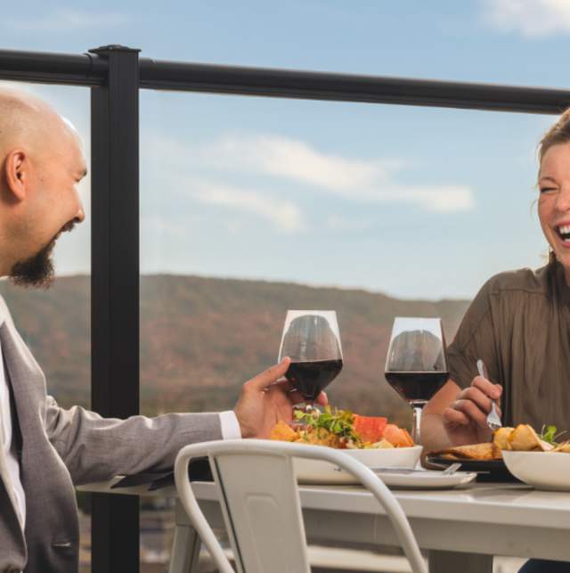 With Rib Mountain in the background, a couple dines at the rooftop restaurant, The Velveteen Plum