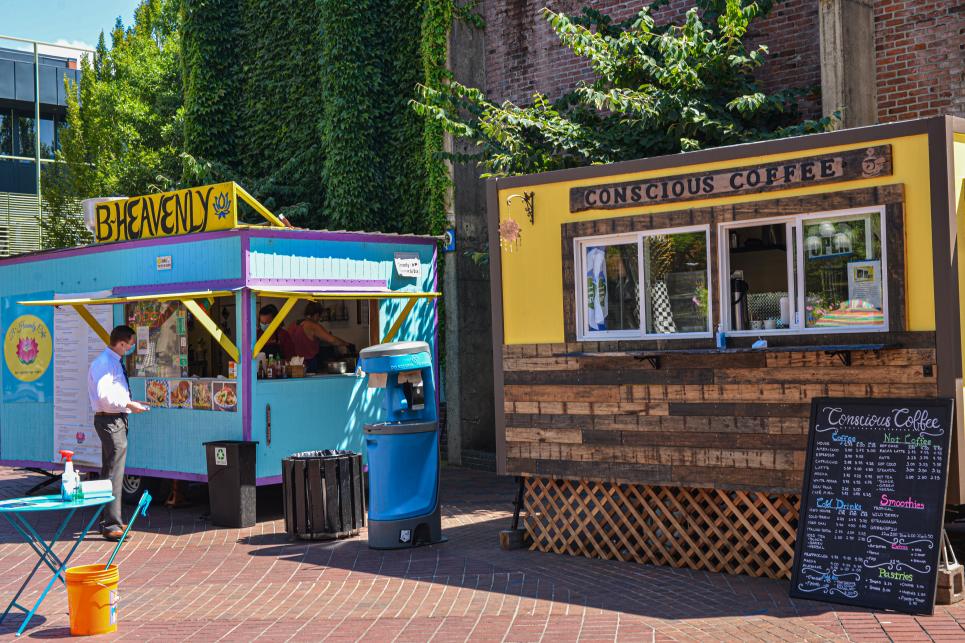 Food trucks at Kesey Square painted in bright colors.