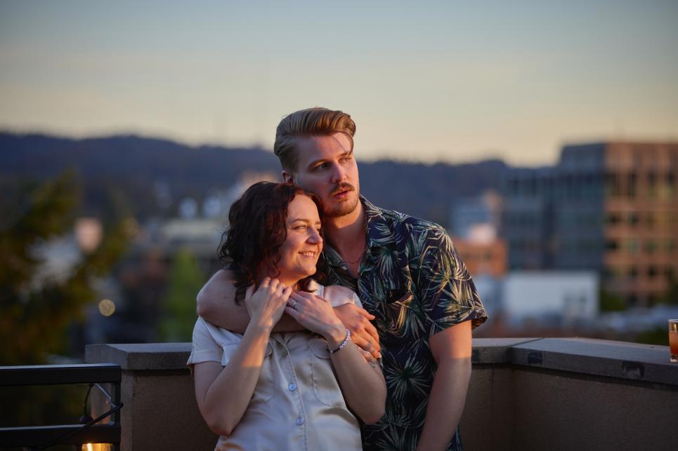 Couple on the roof deck watching the sunset.
