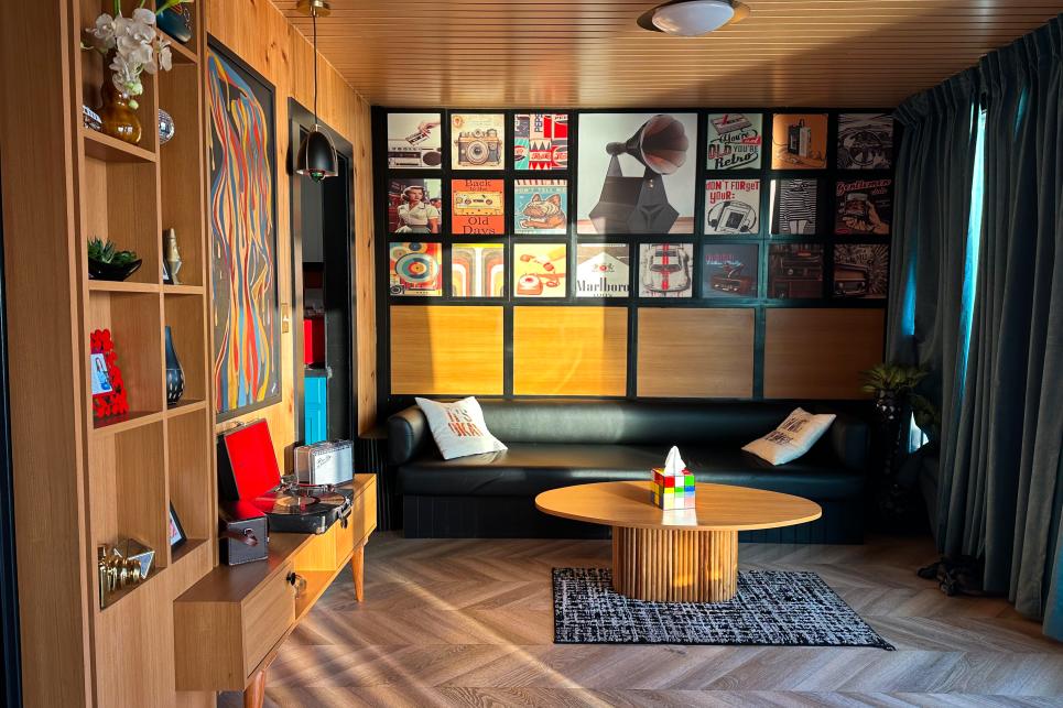 A contemporary room decorated with record album covers and blocky, bright colors.
