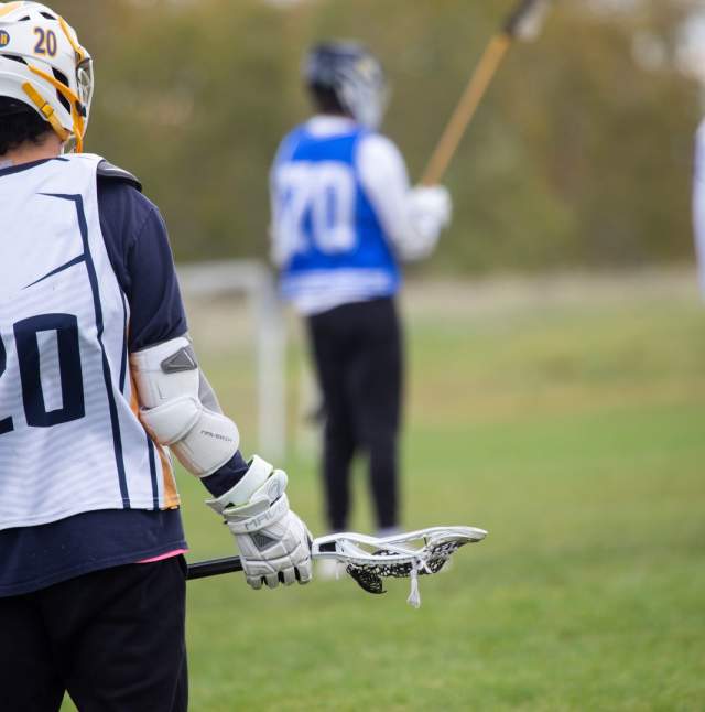 Lacrosse players on the field
