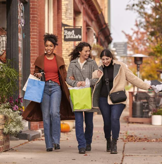 Three women walking down the street in Old Town with shopping bags