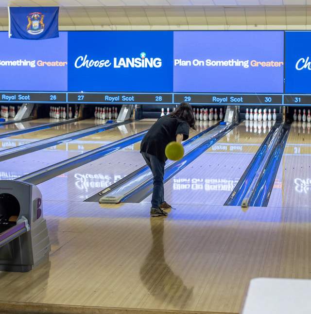 Person on a bowling lane about to throw the ball at Royal Scot Golf and Bowl