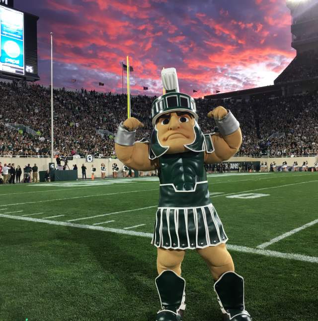 Michigan State University's Mascot, Sparty, standing on the turf of Spartan Field.