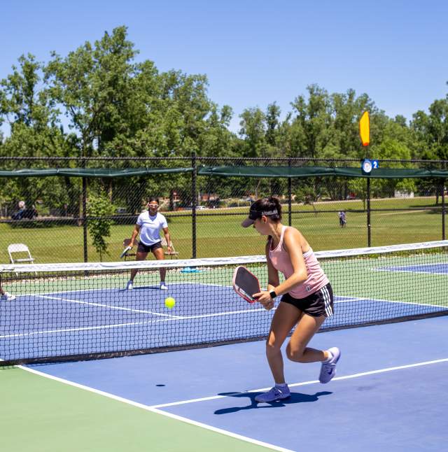 A group of people playing pickleball at the courts at Delta Mills Park