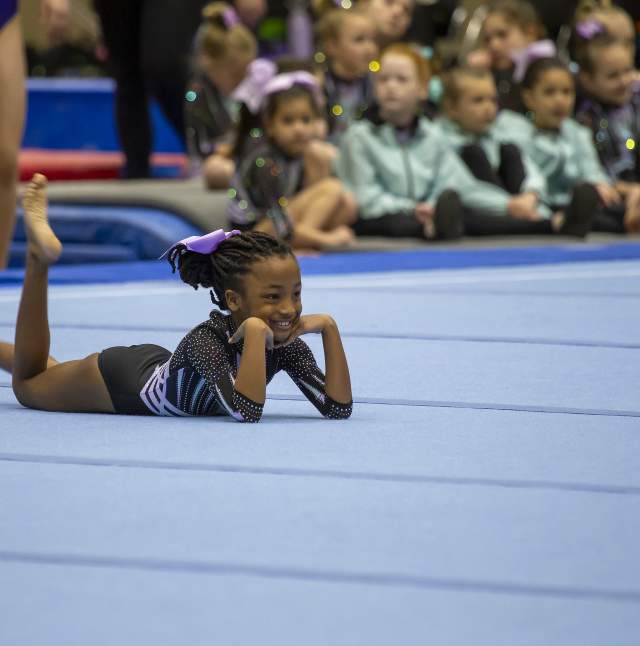 Athlete posing at the end of her performance on the mat
