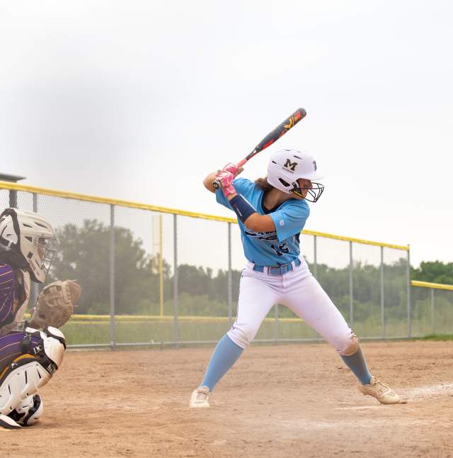 A player lining up at the plate to hit the ball